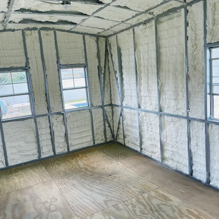 Closed-cell spray foam insulation applied to wall cavities in a residential project in Queensbury